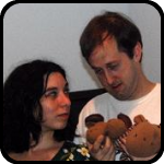 Man and Woman Holding Small Stuffed Moose Heads Man and Woman Holding Small Stuffed Moose Heads