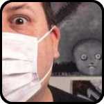 Weird Nik in face mask with weird thing peering over his shoulder.