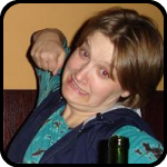 Brit and Rosalie punching a hole in a paper mache hedgehog