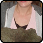 Woman Holding a Heavy Stone That Looks Like a Face Woman Holding a Heavy Stone That Looks Like a Face